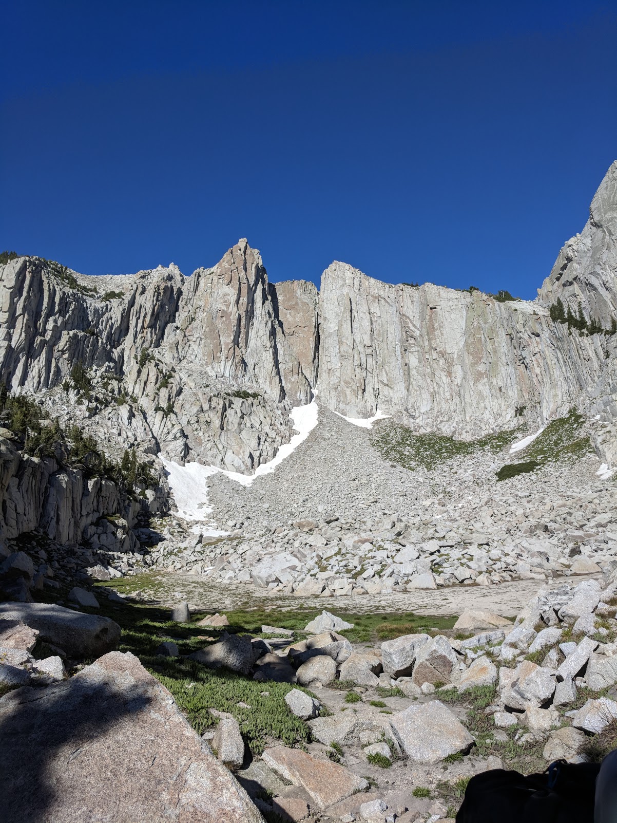 The sheer granite walls of the Lone Peak cirque with lingering snowfields