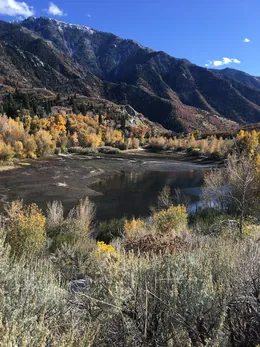 Lower Bells Canyon Reservoir at low autumn water level, surrounded by golden scrub oak and maple