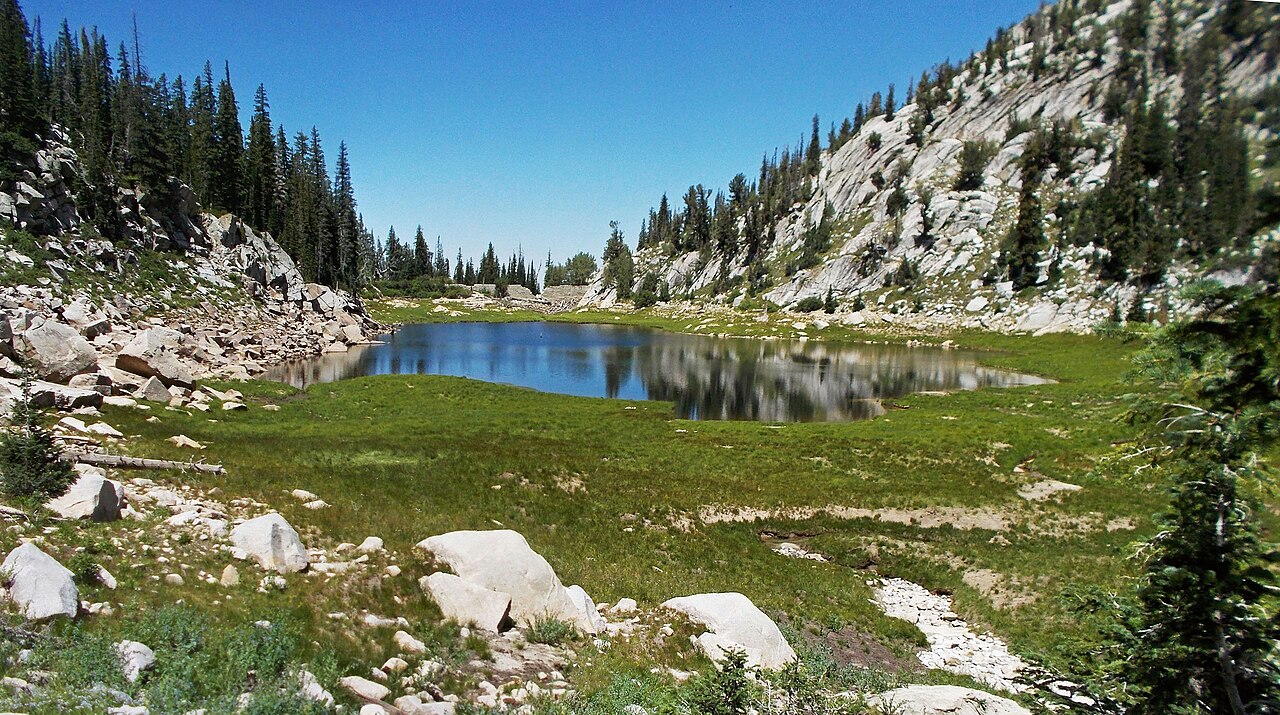 Upper Bells Canyon Reservoir, a small alpine tarn surrounded by granite slabs and pines