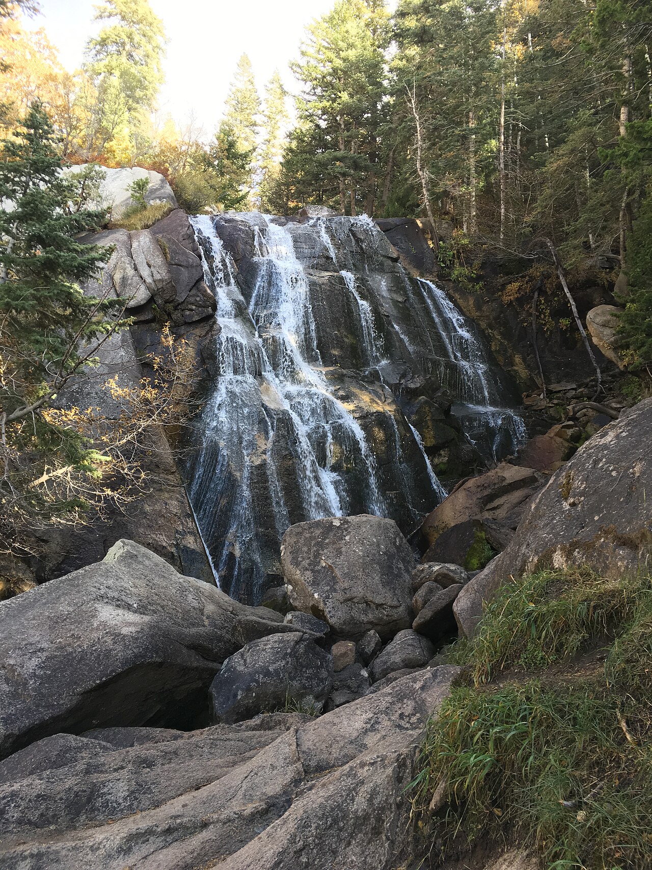 The first waterfall fanning over polished granite slabs in Bells Canyon